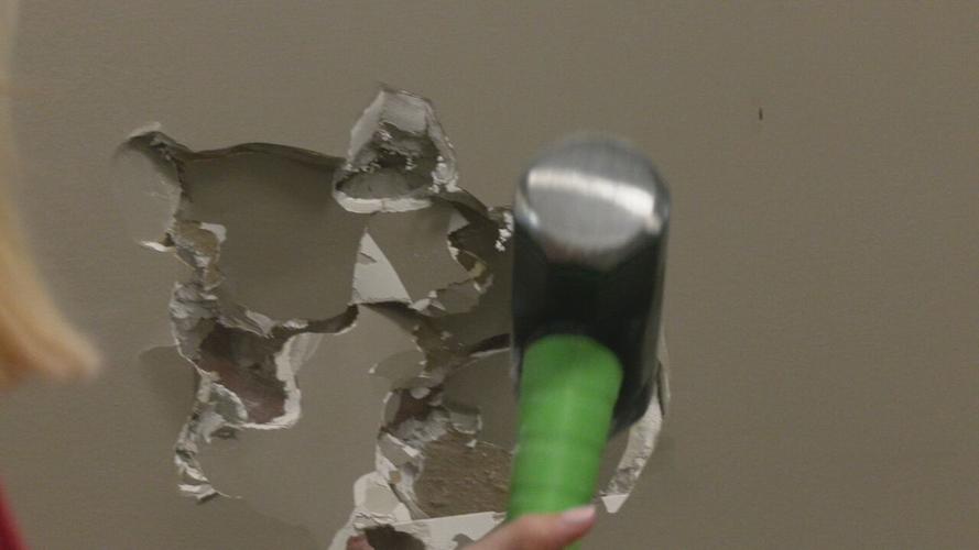 Ivy Tech Sellersburg staff members swing sledgehammers to launch remodeling project