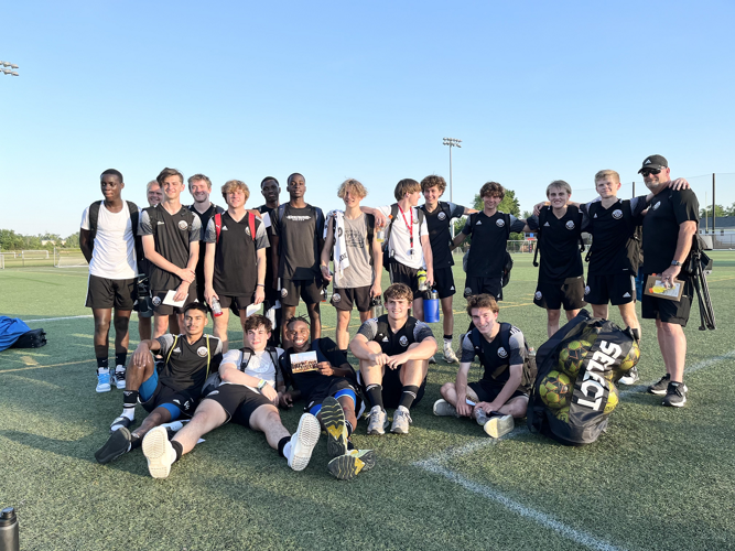 Lee Smith poses with soccer team