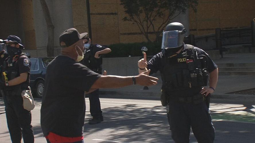 Anti-eviction protest man talks with LMPD officer 8-8-20