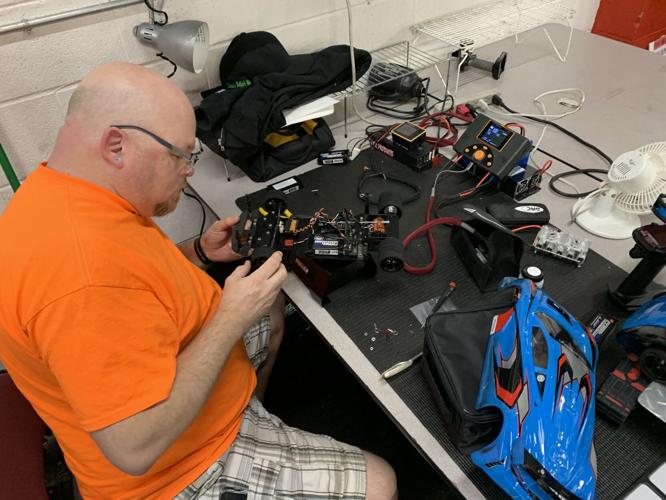 A man fixing a RC race car at Southern Indiana RC speedway - KK - 3.31.23