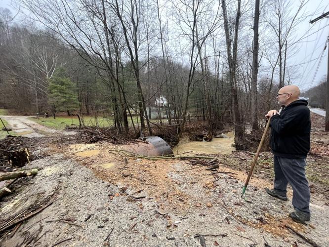 A man moves debris from a bridge after Jan. 3, 2023 flooding in Bullitt County