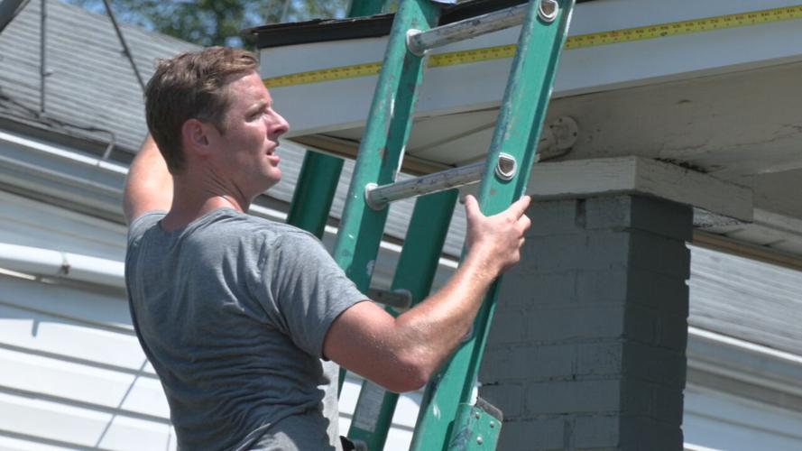 University of Louisville football players help repair a home in the Portland neighborhood