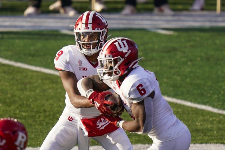 Indiana quarterback Michael Penix Jr. (9) hands off to running back Sampson James