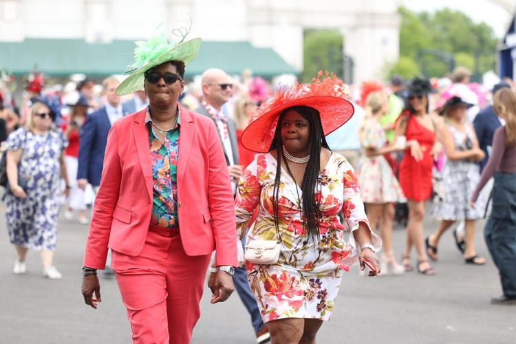 Two people walk wearing red at Derby.JPG