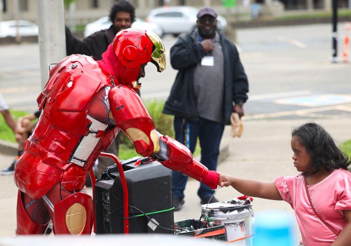 Man dressed as Iron Man gives a fist bump.JPG