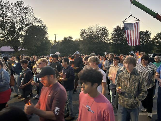 People stand in a vigil for Bryce Gerlach - Harvest Homecoming shooting