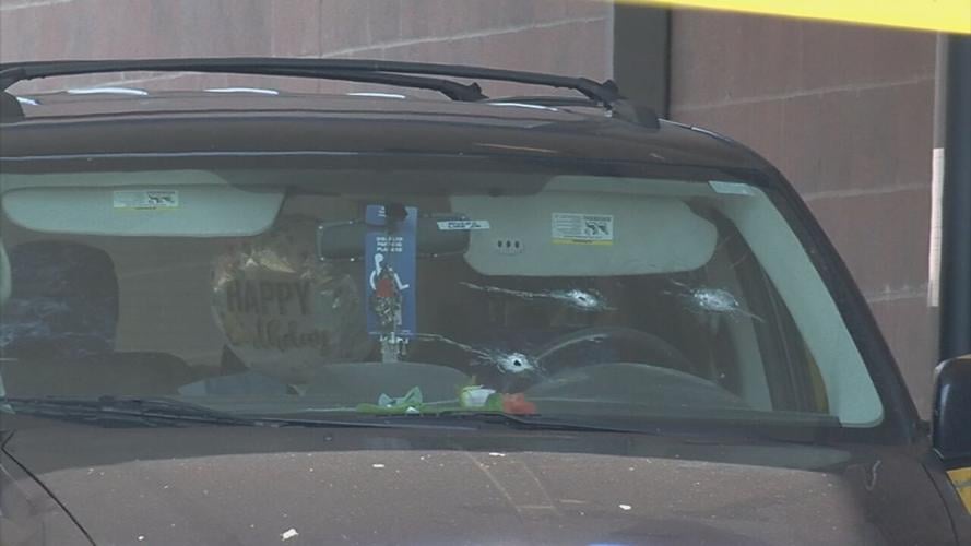 Bullet holes in windshield of minivan outside Walmart pharmacy drive-thru