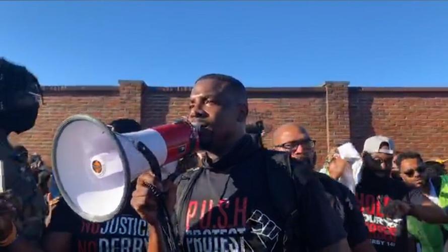 Tim Findley talks to Louisville protesters outside Churchill Downs on Derby day