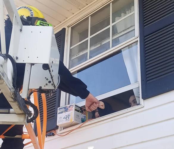 Shelbyville Fire & Rescue firefighter gives fistbump to 'DJ' before decorating home with Christmas lights