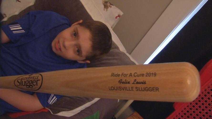 Felix Lewis (cancer survivor) with his personalized Louisville Slugger bat