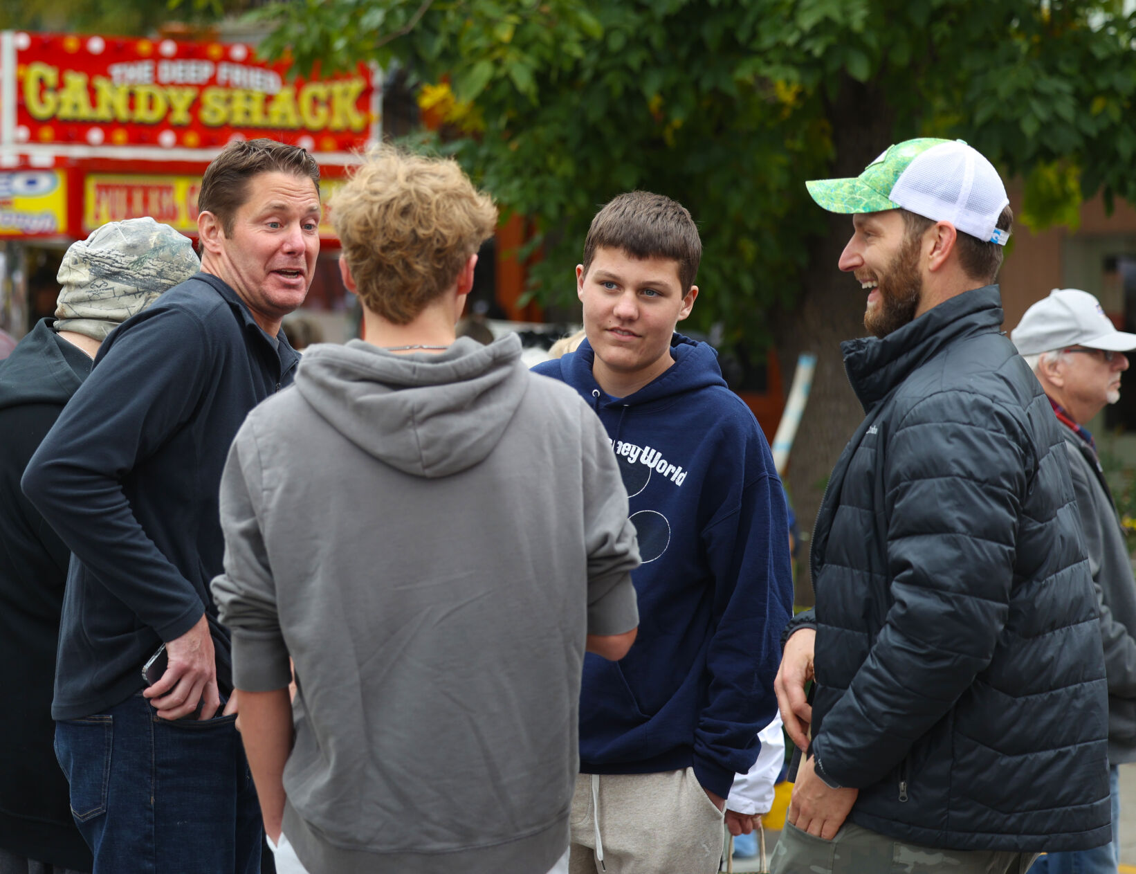 Group laughs during conversation at Harvest Homecoming.JPG