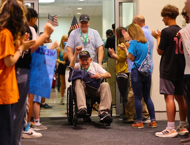 Veteran raises fist at Honor Flight Return Home.JPG