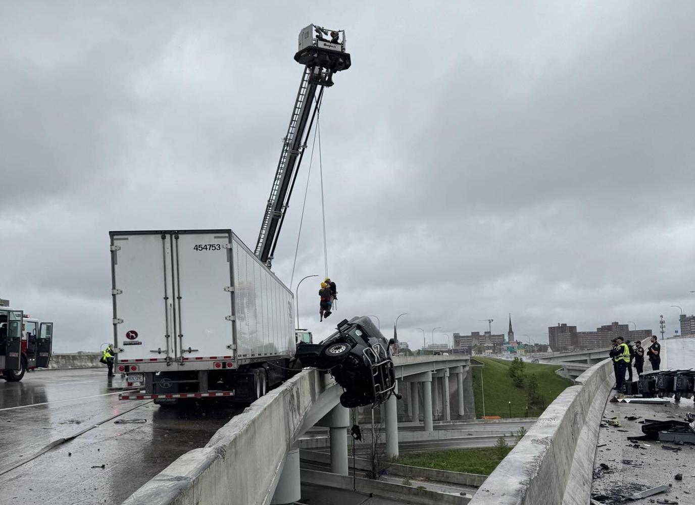Emergency crews rescue driver as semi dangles over Kennedy Bridge in ...
