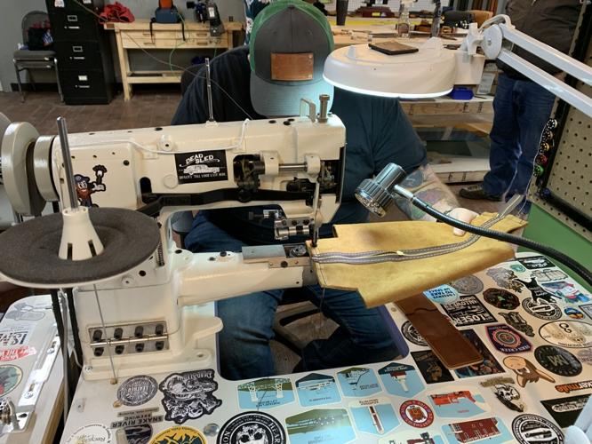 A craftsman at the Dead Sled Leather Company