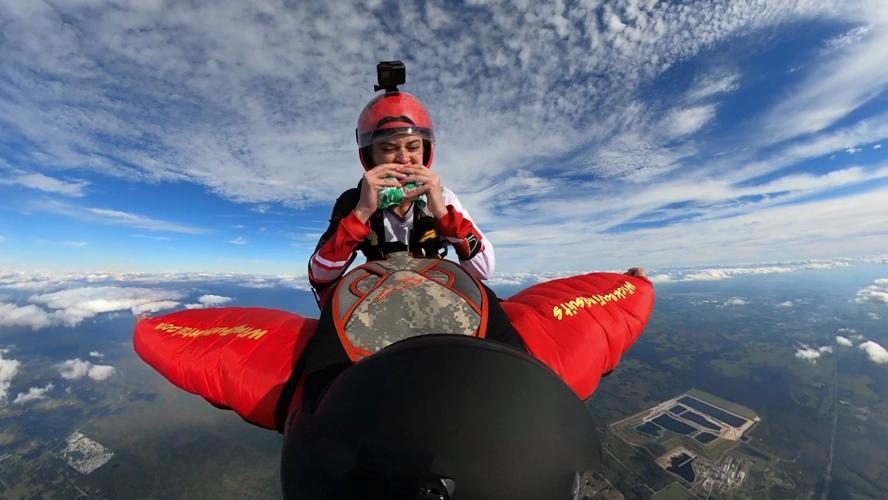 McKenna Knipe bites into Burger King sandwich while skydiving