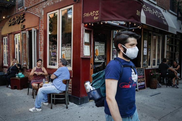 Customers dine outside NYC bar