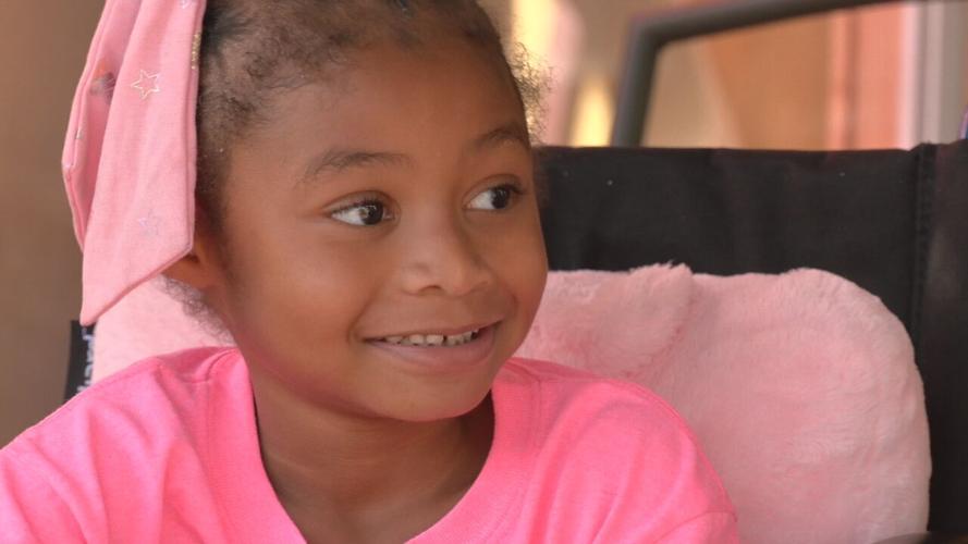 LaMiya Erve smiles while sitting outside with family
