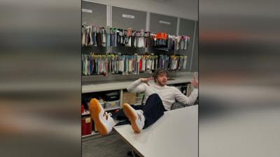 Jack Harlow poses with new soccer shoes from New Balance