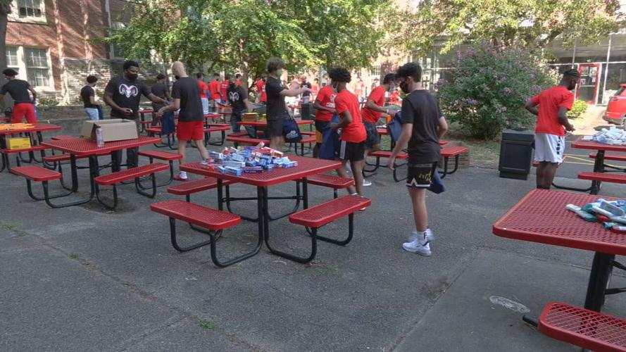 DuPont Manual boys basketball team stuffs backpacks.jpeg