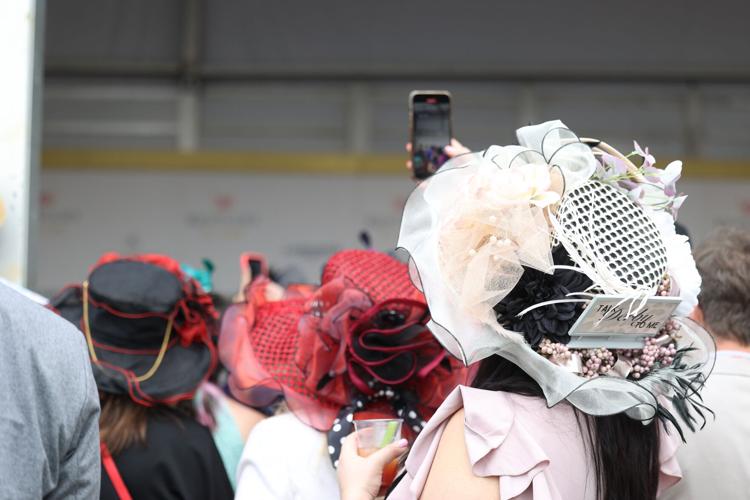 Woman holds up phone at red carpet.JPG