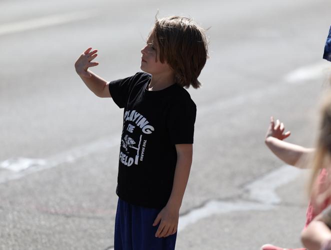 Boy waves during 2022 Pegasus Parade