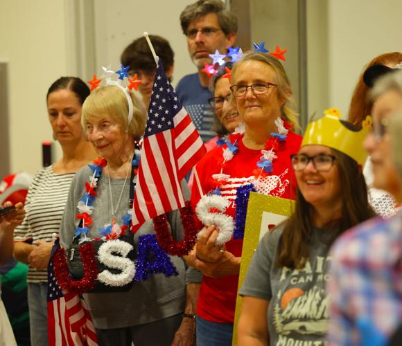 People wearing American flag decor at Honor Flight Return Home.JPG