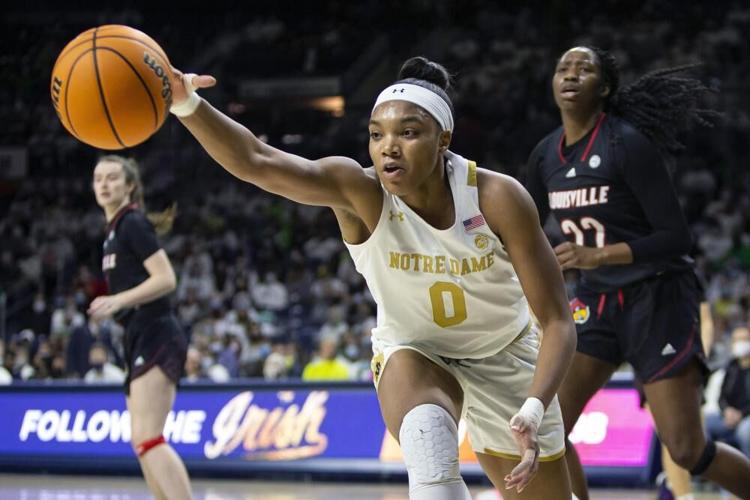 Notre Dame's Maya Dodson reaches for a loose ball in front of Louisville's Liz Dixon.jpeg