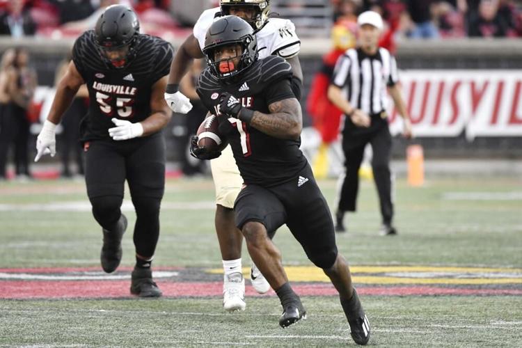 Louisville running back Tiyon Evans runs from the Wake Forest defense.jpeg