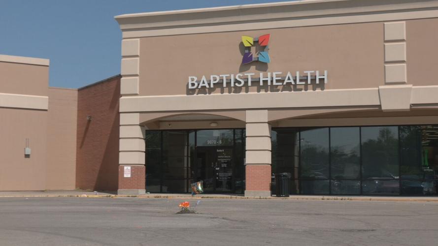 Fake flowers planted in pothole outside primary care office on Dixie Highway