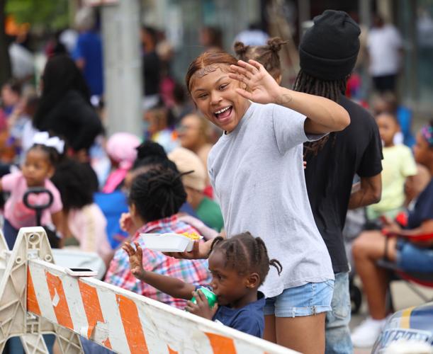 Woman waves and child watches parade.JPG