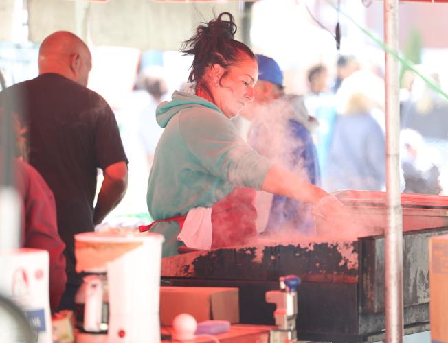 Woman works at grill at Chow Wagon.JPG