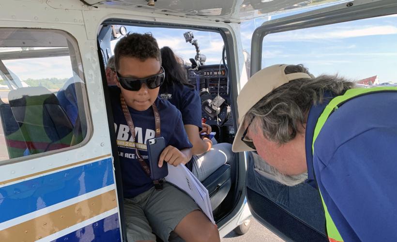 Student in the OBAP Shawnee ACE Academy taking a flight on a small plane at Louisville's Bowman Field