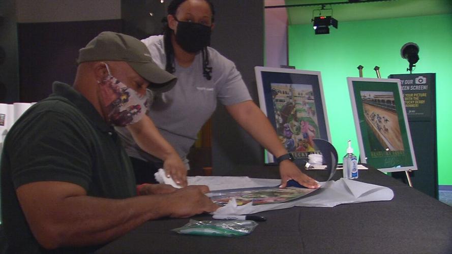 Derby artist Keith Anderson signs artwork the day after Derby 146