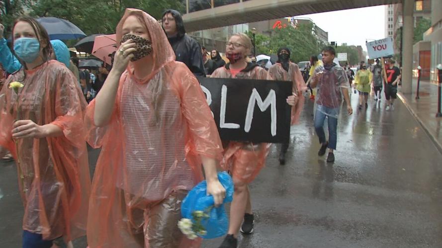 Protesters demonstrating for Breonna Taylor carry 'BLM' signs
