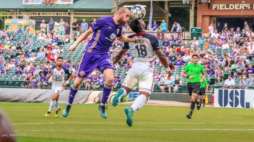 Louisville City FC midfielder Brian Ownby goes up for the ball