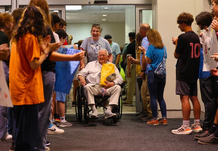 Veteran goes through final part of crowd at Honor Flight Return Home.JPG