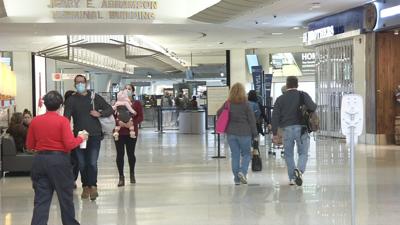 Travelers walk through the Louisville Muhammad Ali International Airport