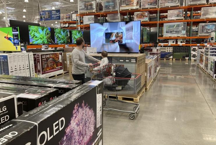 Costco customer looks at TVs