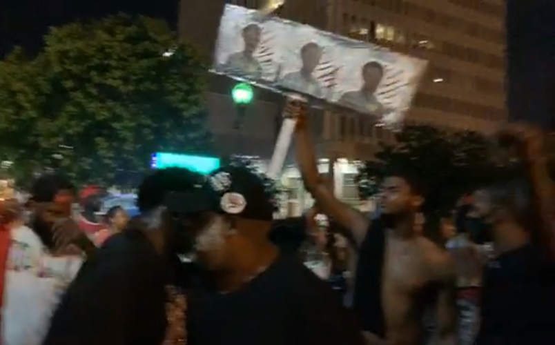 Man holds up a Breonna Taylor sign during protests in Jefferson Square Park 7-01-20