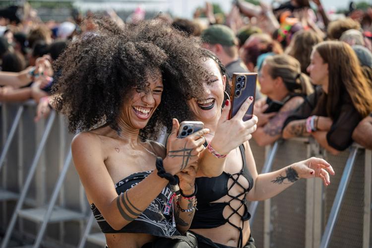 Fans check their crowd surfing videos after their rides at the Louder Than Life Festival on September, 21, 2025 in Louisville, Kentucky (27 of 175).jpg