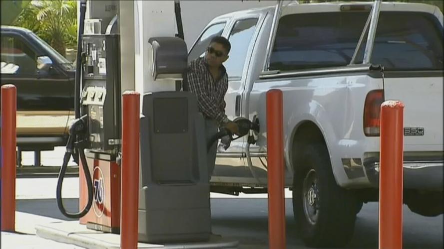 Person pumps gas into truck.jpeg