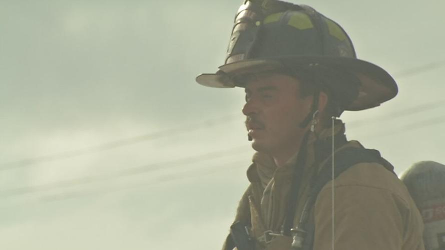Firefighter with fire department at fire scene