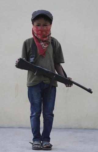 Young Mexican child with fake rifle