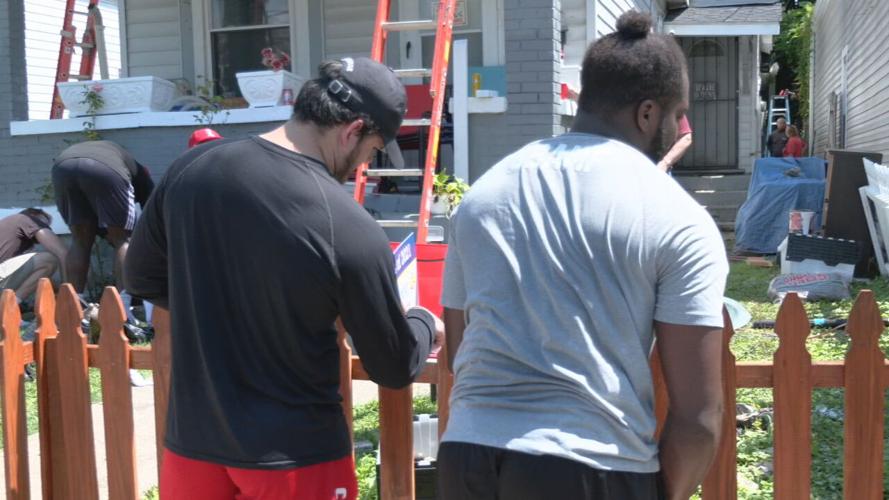 University of Louisville football players help repair a home in the Portland neighborhood