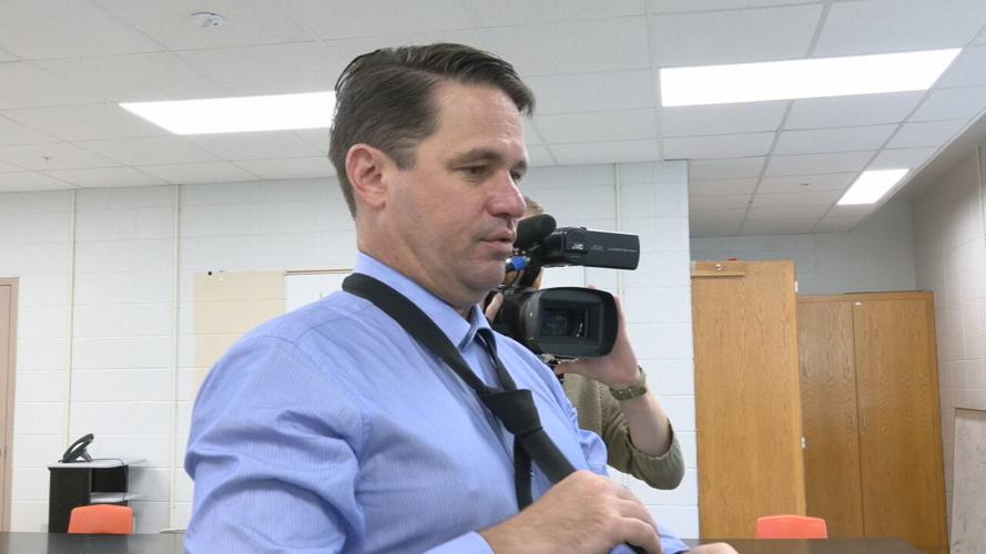 JCPS Superintendent Dr. Marty Pollio demonstrates how to knot a necktie