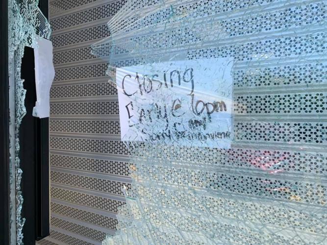 Game Stop sign about closing early during Louisville's curfew