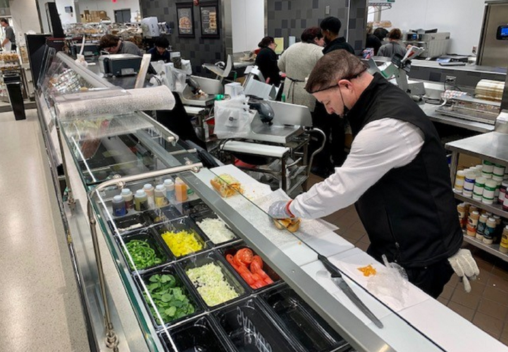 Workers prep food at Publix Super Market in Middletown