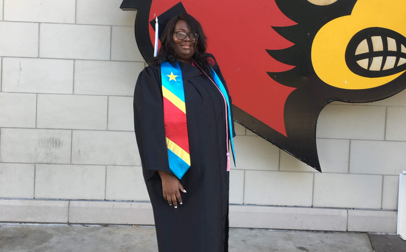 Marie-Ange Mbumba near Cardinal emblem