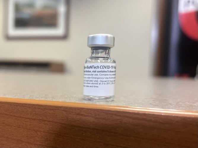 Dr. Jason Smith displays vial of Pfizer vaccine