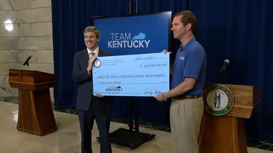 Ky Gov. Andy Beshear presents Jeff O'Brien, the director of Develop Louisville, with a check for $27 million worth of federal funds to keep residents from being evicted